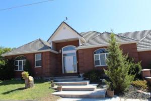 a brick house with a front door and stairs at Swallow Cove in Panaca