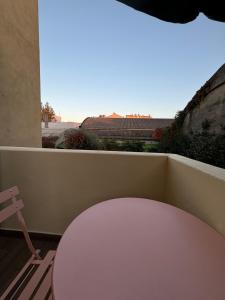 a white table and a chair on a balcony at Luminoso alloggio sul mare in Cattolica