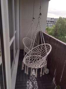 a hammock hanging on a balcony with a window at Le Brossolette 3 in Saint-Denis