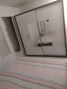 a mirror on the wall of a room with a bed at Le Brossolette 3 in Saint-Denis