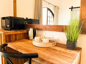 a counter with a microwave and a table with candles at The Lux Guesthouse in Kroonstad +69 photos