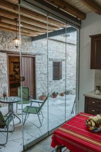 a room with a glass door and a table and chairs at Ariadni Cottage in Vasa