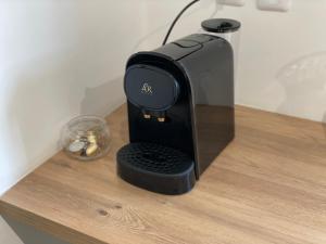 a coffee maker sitting on a wooden table at Maison proche Loire et Châteaux in Meung-sur-Loire +5 photos