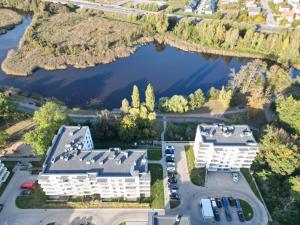 an aerial view of a building and a lake at Riverside - nad rzeką, centrum, Netflix i Max, parking, winda in Iława