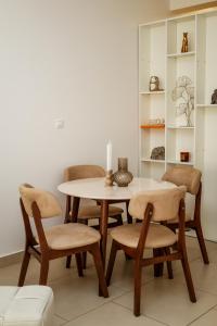 a dining room with a table and four chairs at Morinj Lavender Bay Apartment E3 in Donji Morinj