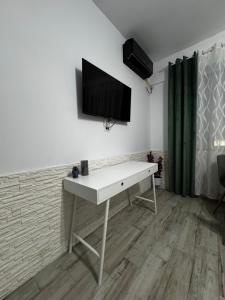 a white desk with a television on a wall at Apartament MaGiFa Mamaia Nord in Năvodari +14 photos