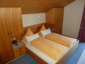 a bedroom with a bed with a wooden head board at Ferienwohnung Panorama in Bad Kohlgrub