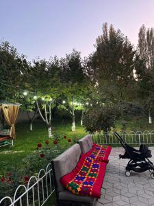 a couch with a colorful blanket on a patio at Дом 14 in Osh