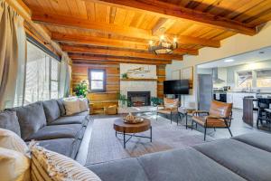 a living room with a couch and a table at Hot Tub, Game Room and Fire Pit Canton Log Cabin in Canton