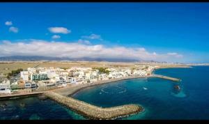 an aerial view of a beach with buildings and the water at casa CARIN in Pozo Izquierdo