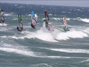 a group of people windsurfing in the ocean at casa CARIN in Pozo Izquierdo +17 photos