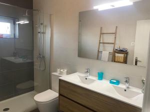 a bathroom with a sink and a toilet and a mirror at O Ninho 94 in Vila Praia de Âncora +13 photos
