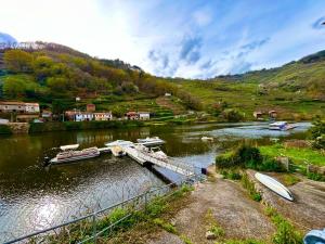 a river with boats docked at a dock at Casa Lamela in Villasante