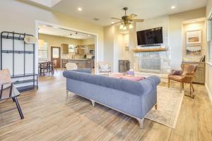 a living room with a blue couch and a tv at Scenic Views, Fire Pit Texas Hill Country Getaway in Fischer