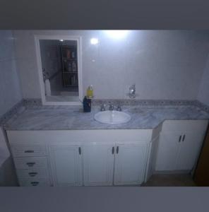 a bathroom counter with a sink and a tub at La casa de la ti in Lanús