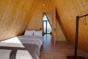 a room with two beds in a wooden house at TITA HOMES in Telavi