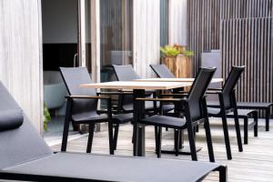 a wooden table and chairs in a room at Céleste Beauté & Spa in Nalinnes +29 photos