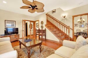 a living room with a couch and a table at Family Friendly Cottage 9 Logan in Tybee Island