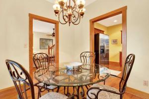 a dining room with a glass table and chairs at Family Friendly Cottage 9 Logan in Tybee Island