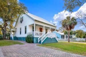 a blue and white house with a porch at Family Friendly Cottage 9 Logan in Tybee Island