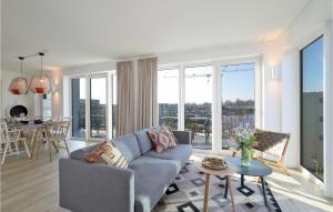 a living room with a couch and a table at Penthouse Comfort in Lembruch