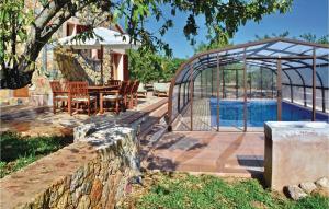 a patio with a table and chairs next to a swimming pool at Amazing Home In Santa Maria in Santa Maria del Camí