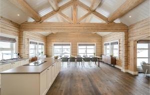 a kitchen with wooden walls and a ceiling with windows at Lovely Home In Sjusjøen With Sauna in Sjusjøen