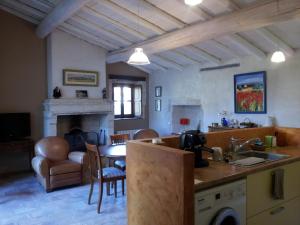 eine Küche und ein Wohnzimmer mit einem Tisch und einem Esszimmer in der Unterkunft Le Petit DoMeynes in Meynes