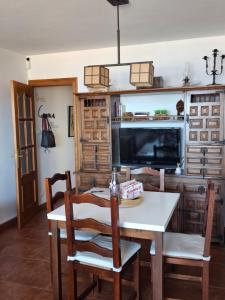 a dining room with a table and a tv at Frente al mar, Doña Carmen Playa, Mejor vista de Suances in Suances +37 photos
