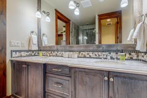 a bathroom with a sink and a large mirror at Mountain Breeze Retreat in Edwards
