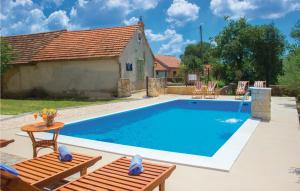 a swimming pool in front of a house at Four-Bedroom Holiday Home In Miljevci in Brištane +43 photos