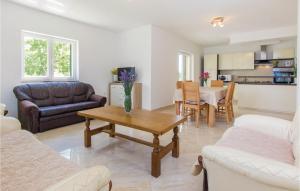 a living room with a couch and a table at Four-Bedroom Holiday Home In Miljevci in Brištane