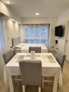 a room with two beds and a table and chairs at Premium Apartment in City heart in Buenos Aires +5 photos