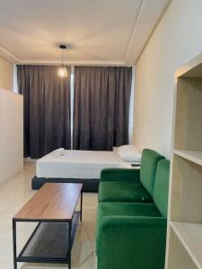 a room with a couch and a bed and a table at Studio confortable in Tangier