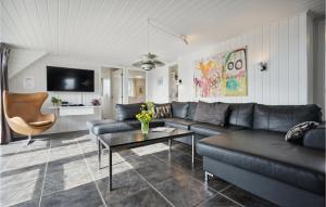 a living room with a couch and a table at Beautiful Home In Fanø With Sauna in Fanø