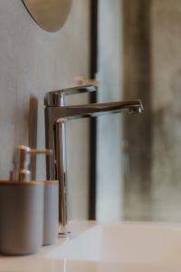 a bathroom sink with a chrome faucet at Sunset de los Andes Lodge in Ciudad Lujan de Cuyo +18 photos