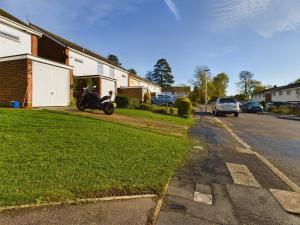 a motorcycle parked on the side of a street at 3 bed beautiful home which sleeps up to 6 in Tilehurst