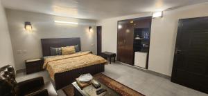 a bedroom with a bed and a black door at LvL 50 in Murree