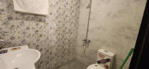 a bathroom with a toilet and a sink at LEVEL FIVE ZERO in Murree