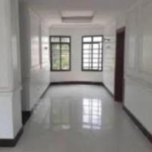 an empty room with white walls and windows in a building at Satesquire Homes in Ajangboju