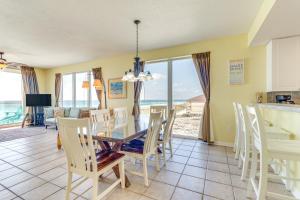 a dining room with a table and chairs and the ocean at Vibrant Navarre Condo Pool and Beach Chair Service! in Navarre