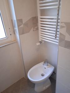 a white bathroom with a toilet and a sink at Casa Patrizia in Lavagna +20 photos