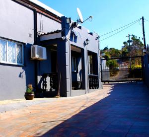 a blue and white building with a window and a door at The Bethel House in KwaDabeka