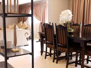 a dining room with a table and chairs at The Bethel House in KwaDabeka