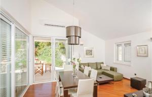 a living room with a couch and a table at Holiday Home Primosten-Dolac With Outdoor Pool in Podgreben