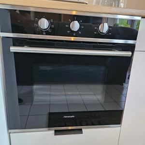 a black oven sitting inside of a kitchen at My Exclusive Sweet Home S62 in Düsseldorf +8 photos