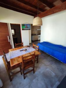 a dining room with a table and a blue bed at Javier 1 in Santa Teresita