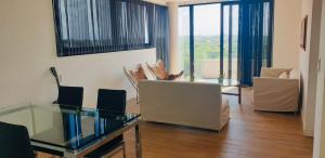a living room with a glass table and chairs at EG12 Playa Grande in Mar del Plata