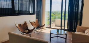 a living room with a couch and chairs and a table at EG12 Playa Grande in Mar del Plata