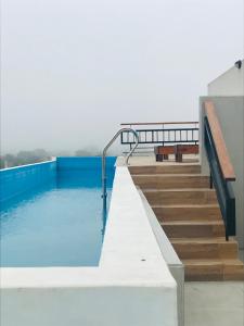 a swimming pool with stairs and blue water at EG12 Playa Grande in Mar del Plata